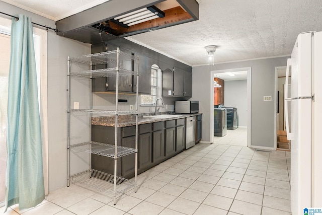 1877 Old Sylacauga Hwy, Sylacauga, AL 35150 - kitchen with stainless steel appliances, light tile patterned flooring, a sink, and crown molding