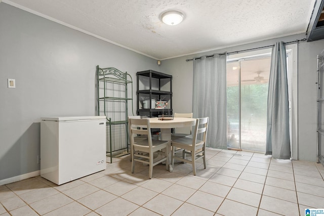 1877 Old Sylacauga Hwy, Sylacauga, AL 35150 - dining room with light tile patterned floors, ornamental molding, a textured ceiling, and baseboards