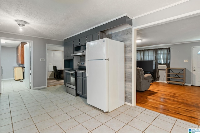 1877 Old Sylacauga Hwy, Sylacauga, AL 35150 - kitchen with light tile patterned floors, appliances with stainless steel finishes, dark cabinets, light countertops, and crown molding