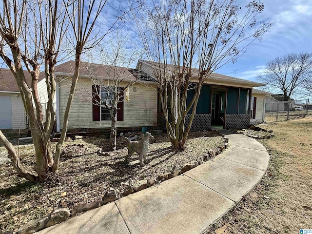 ranch-style home featuring fence