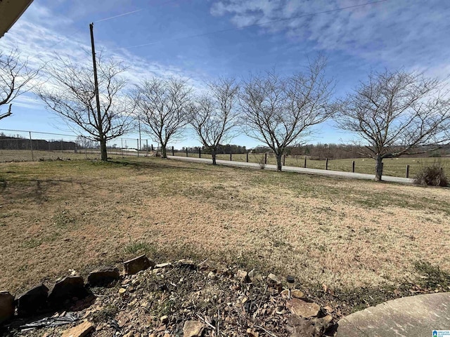 view of yard featuring a rural view and fence