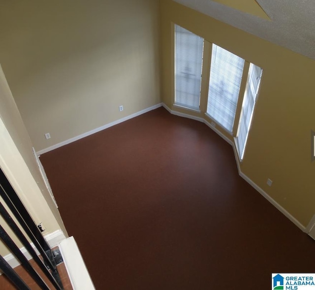 spare room featuring baseboards