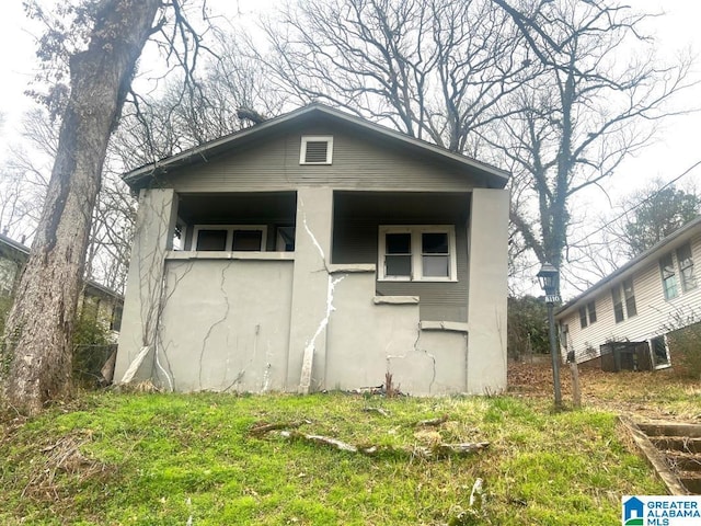 exterior space with central AC and stucco siding