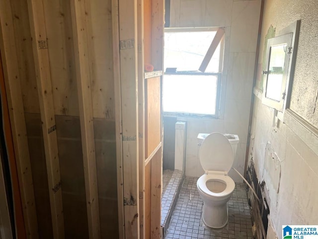 bathroom featuring tile patterned flooring and toilet