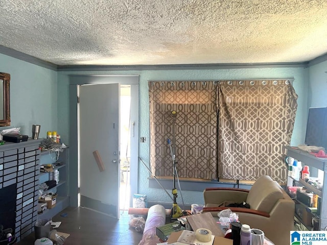 dining space with crown molding, a textured ceiling, and wood finished floors