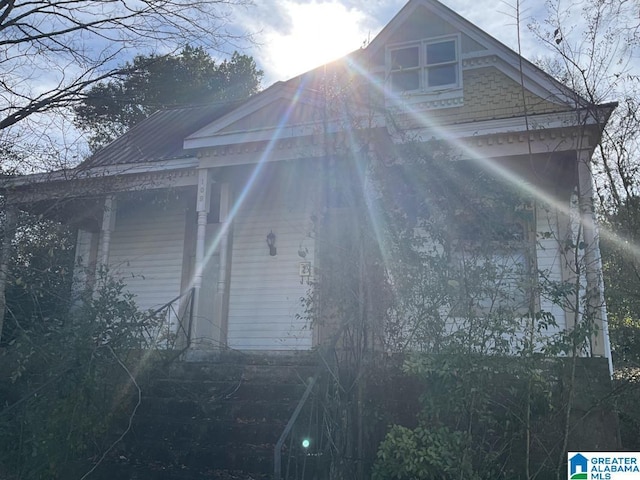 view of side of property with metal roof