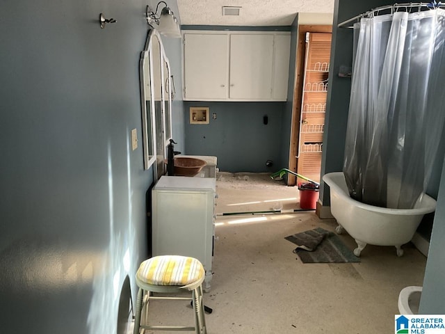 full bath featuring concrete flooring, visible vents, a sink, and a textured ceiling