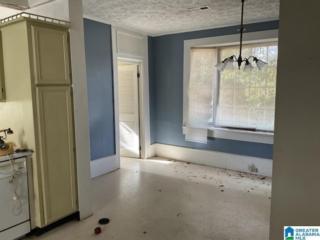 unfurnished dining area featuring concrete flooring, visible vents, a textured ceiling, and an inviting chandelier