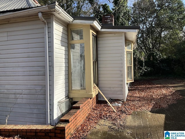 view of side of home with a chimney