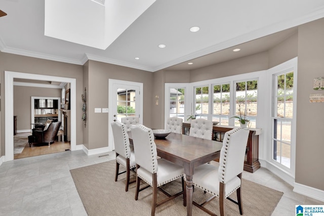 dining area with ornamental molding, recessed lighting, and baseboards