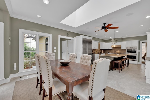 dining area with a healthy amount of sunlight, ornamental molding, and recessed lighting