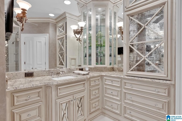 bathroom featuring ornamental molding and vanity