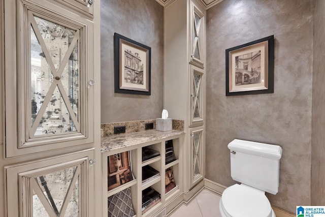 bathroom featuring toilet and tile patterned floors