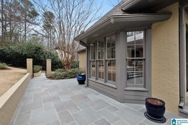 view of patio with a gate and fence