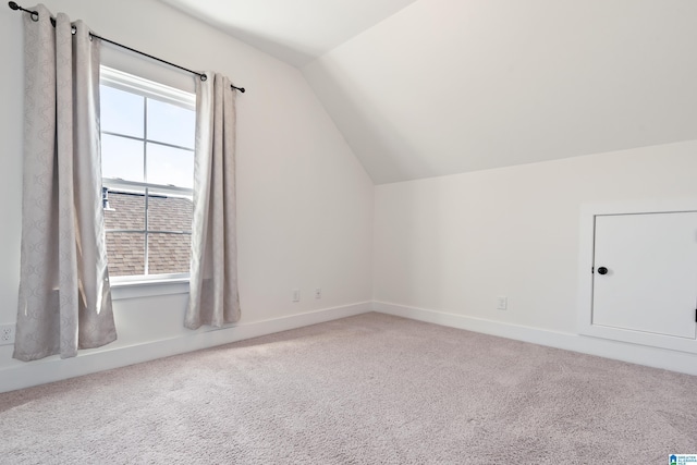 bonus room featuring carpet, vaulted ceiling, and baseboards