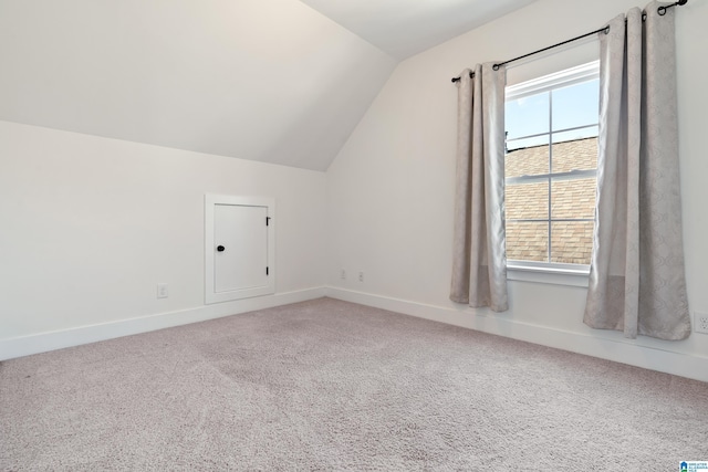 bonus room with lofted ceiling, carpet flooring, and baseboards