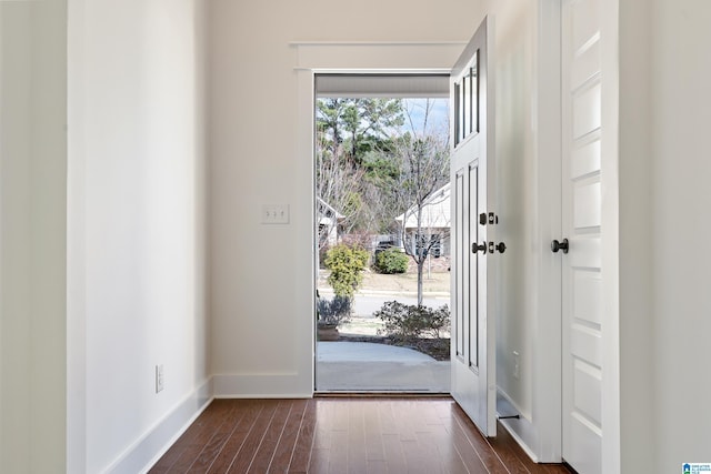 entryway featuring dark wood-style flooring and baseboards