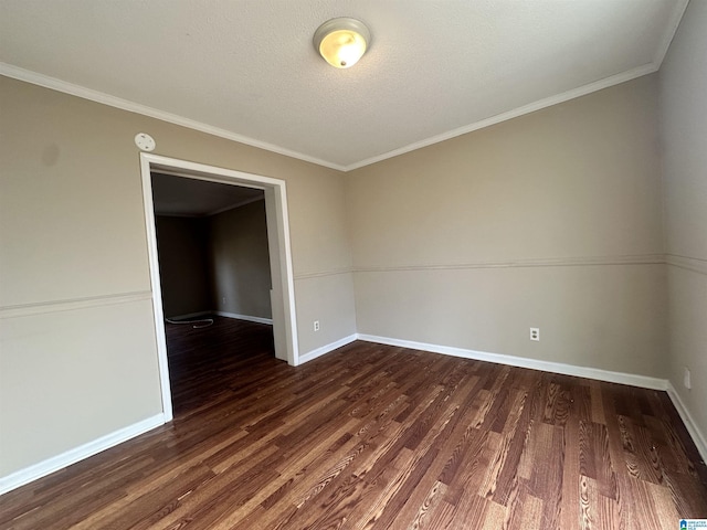 unfurnished room featuring baseboards, dark wood finished floors, a textured ceiling, and ornamental molding