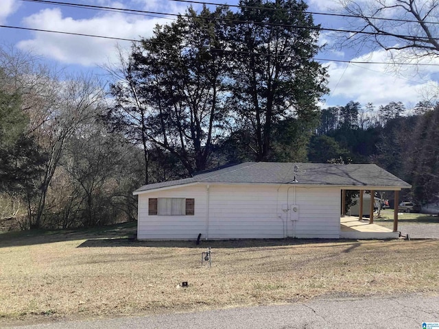 view of side of property with a lawn