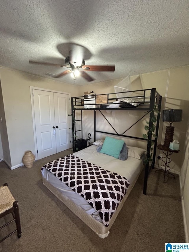 carpeted bedroom featuring a textured ceiling, a closet, and a ceiling fan