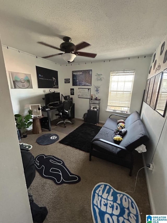 living room featuring a textured ceiling, ceiling fan, carpet, and baseboards