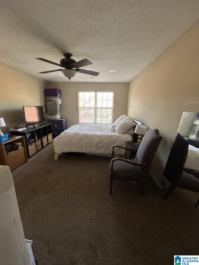 carpeted bedroom with a textured ceiling and a ceiling fan