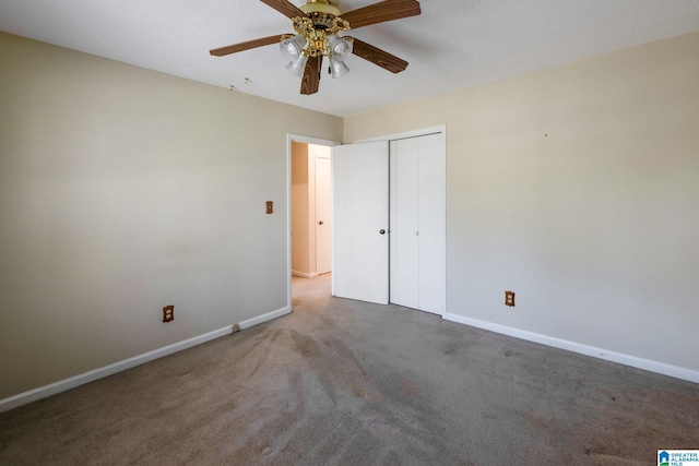 unfurnished bedroom featuring carpet floors, ceiling fan, baseboards, and a closet