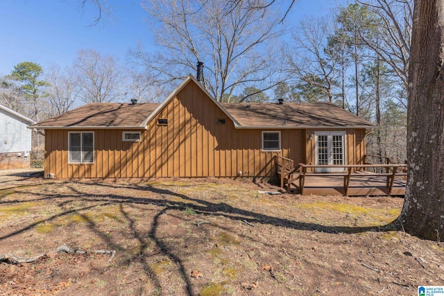 view of front facade featuring board and batten siding, french doors, and a wooden deck