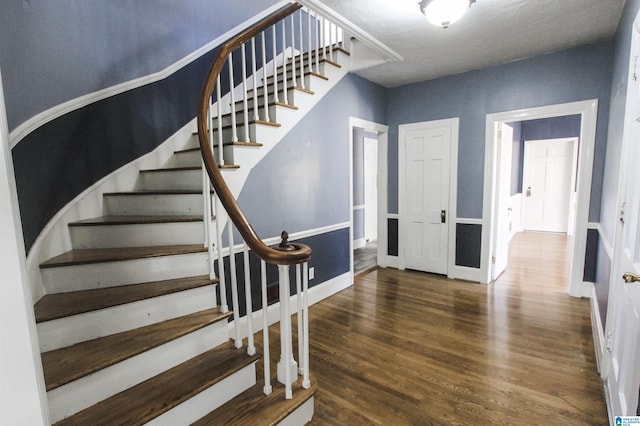 stairway with baseboards and wood finished floors