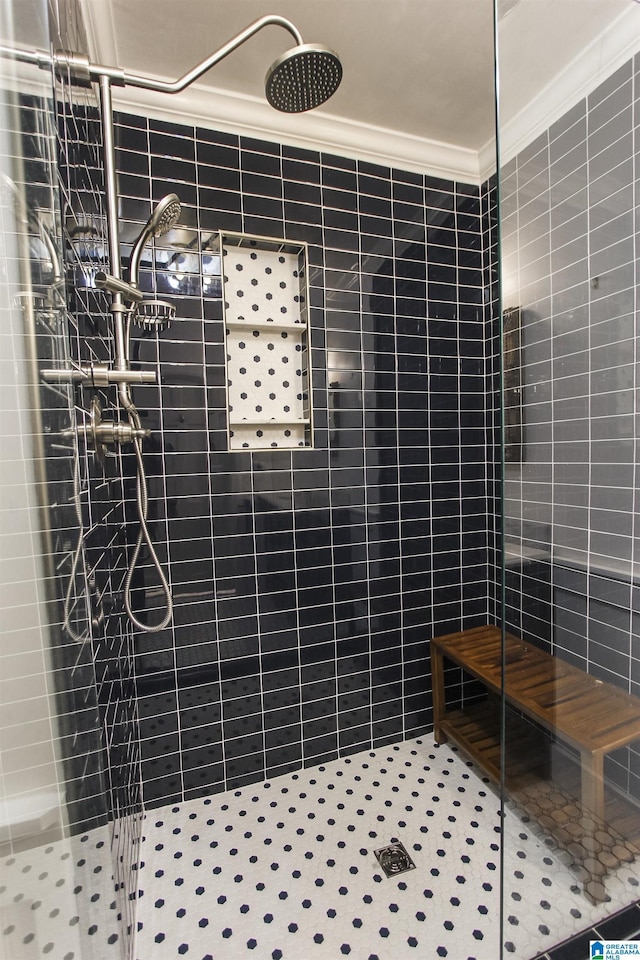 full bathroom with crown molding and tiled shower