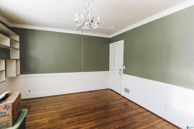 unfurnished room featuring a chandelier, visible vents, ornamental molding, wainscoting, and dark wood finished floors