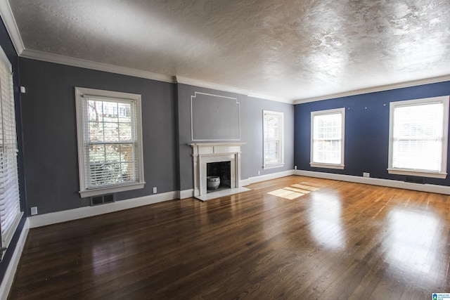 unfurnished living room with baseboards, a fireplace with flush hearth, visible vents, and wood finished floors