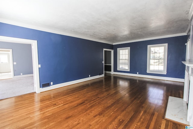 unfurnished room featuring crown molding, dark wood finished floors, and baseboards