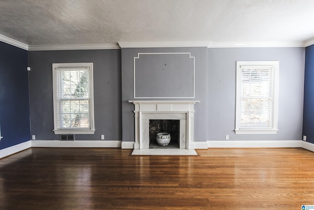 unfurnished living room featuring baseboards, a premium fireplace, wood finished floors, and crown molding