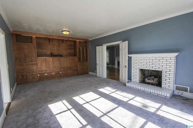 unfurnished living room with ornamental molding, carpet, visible vents, and a fireplace