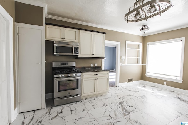 kitchen featuring stainless steel appliances, dark countertops, visible vents, and ornamental molding