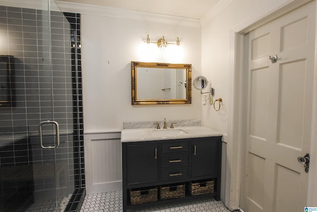 full bath with a stall shower, wainscoting, tile patterned flooring, crown molding, and vanity