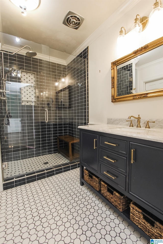 bathroom with visible vents, a stall shower, vanity, and crown molding