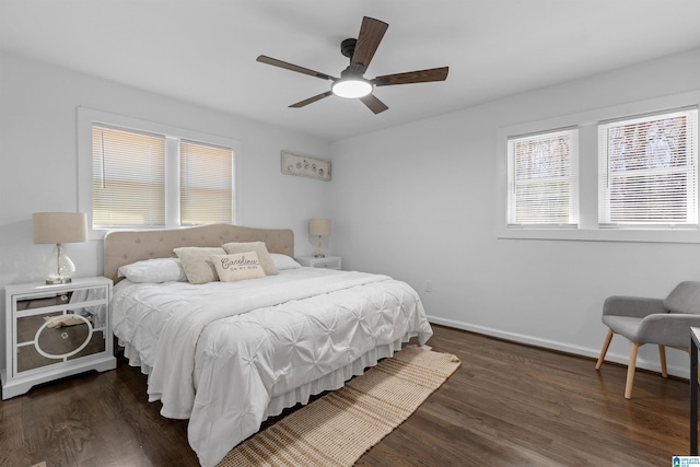 bedroom with ceiling fan, dark wood-style flooring, and baseboards