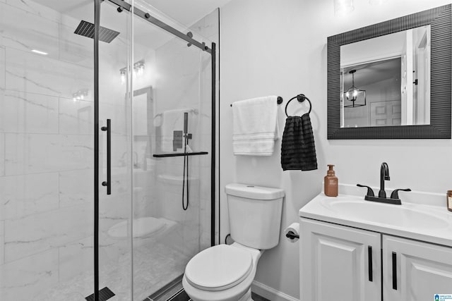 full bath with toilet, a marble finish shower, vanity, and baseboards