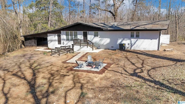 exterior space featuring an outdoor fire pit, crawl space, a patio area, and central air condition unit