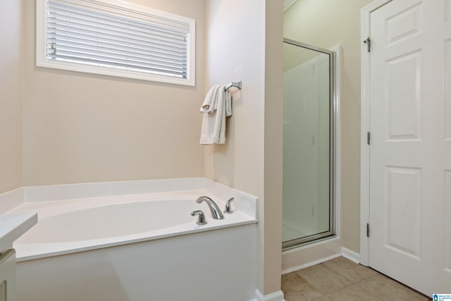 full bath with a shower stall, a bath, and tile patterned floors