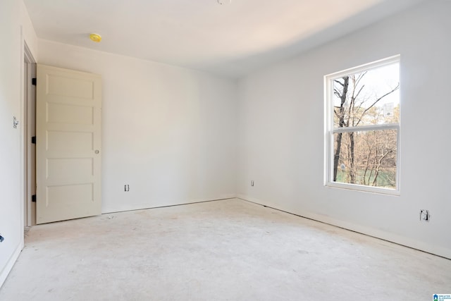 spare room featuring unfinished concrete floors