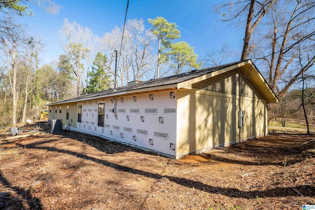 view of side of home with central AC