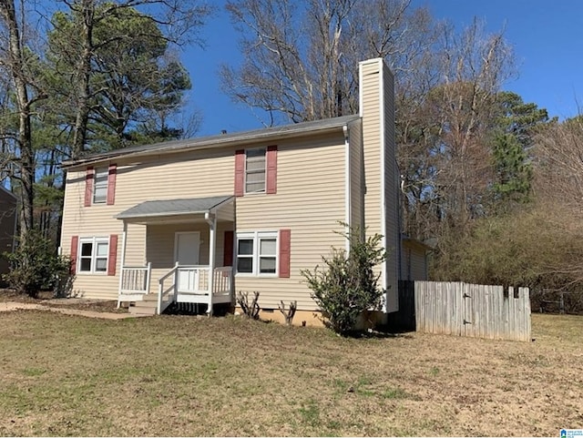 view of front of property featuring crawl space, a chimney, fence, and a front lawn