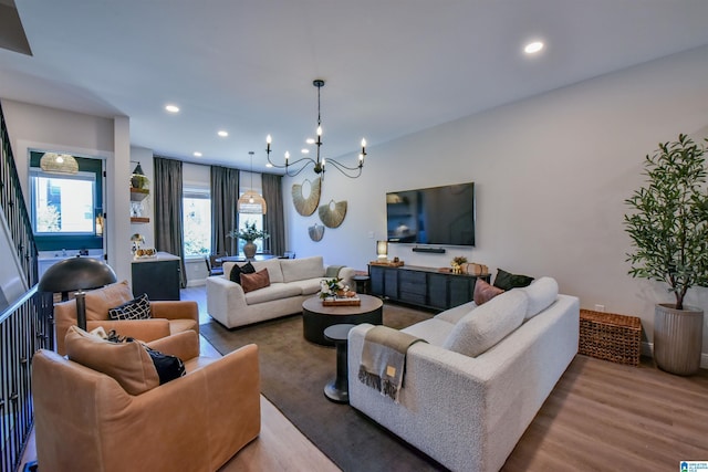 living room featuring a chandelier, wood finished floors, and recessed lighting