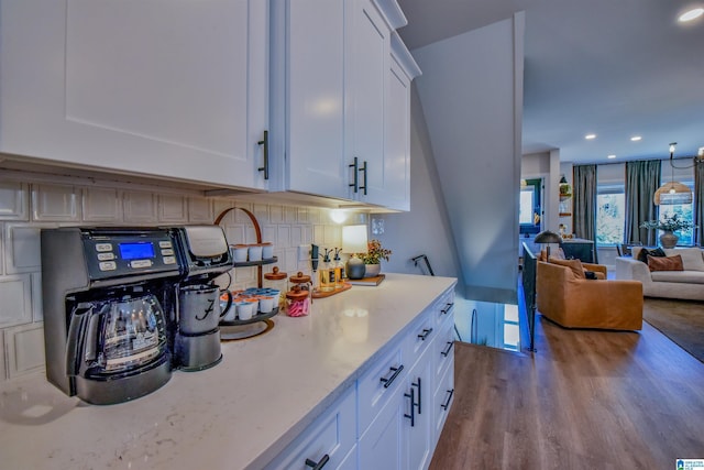 kitchen featuring light wood-style floors, open floor plan, white cabinets, and decorative backsplash