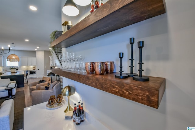 bar featuring recessed lighting, decorative light fixtures, and a dry bar