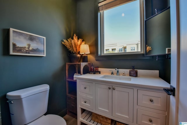 bathroom featuring toilet and vanity