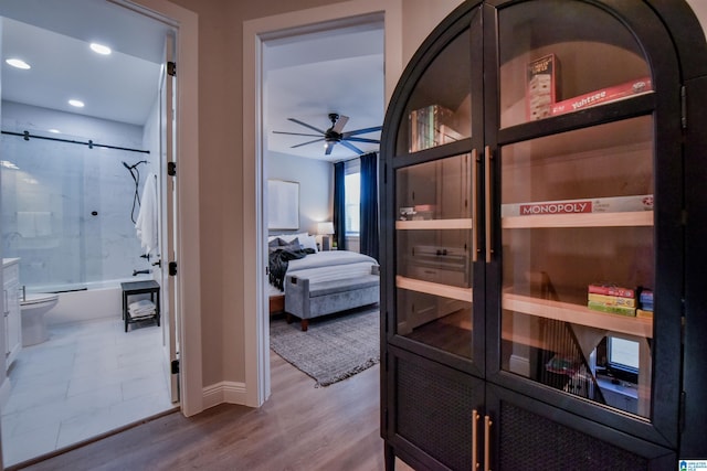 corridor with wood finished floors and recessed lighting